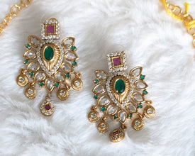 Gold necklace with pink and green gemstones.