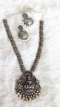 Silver necklace with pendant and matching earrings.