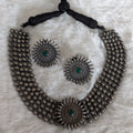 Silver necklace and earrings.