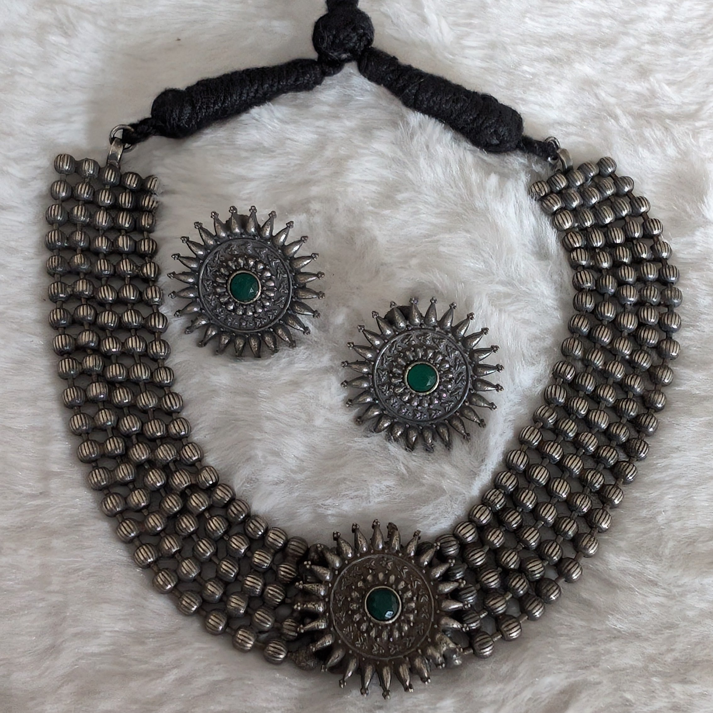 Silver necklace and earrings.