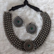 Silver necklace and earrings.